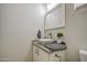 Bathroom featuring a modern vessel sink on a granite countertop with white cabinets at 9413 W Williams St, Tolleson, AZ 85353