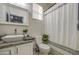 Bathroom featuring a vessel sink on a granite countertop and shower with striped curtain at 9413 W Williams St, Tolleson, AZ 85353