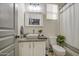 Bathroom featuring modern vanity with granite countertop, stylish fixtures, and plenty of natural light at 9413 W Williams St, Tolleson, AZ 85353