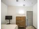 Bedroom features dresser, flatscreen tv, and grey painted doors at 9413 W Williams St, Tolleson, AZ 85353