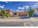 Inviting single-story home featuring a two-car garage, desert landscaping, and a cozy front porch at 9413 W Williams St, Tolleson, AZ 85353