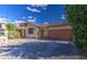 Attractive single-story home featuring a two-car garage and a simple, attractive desert landscape at 9413 W Williams St, Tolleson, AZ 85353