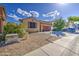 Charming single-Gathering home featuring a two-car garage, desert landscaping, and a welcoming facade at 9413 W Williams St, Tolleson, AZ 85353