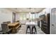 Modern kitchen with a center island, stainless appliances, and a rustic wood table with bench seating at 9413 W Williams St, Tolleson, AZ 85353