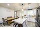 Bright kitchen with an island and wooden table with bench seating next to a door at 9413 W Williams St, Tolleson, AZ 85353