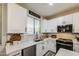 Bright kitchen with white cabinets, stainless steel appliances, and herringbone tile backsplash at 9413 W Williams St, Tolleson, AZ 85353