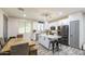 Spacious kitchen featuring an island with barstool seating and adjacent wood dining table at 9413 W Williams St, Tolleson, AZ 85353
