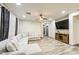 Spacious living room with a comfortable gray sectional, wood-look floors, and a ceiling fan at 9413 W Williams St, Tolleson, AZ 85353