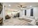 Open-concept living space featuring a comfortable gray sectional sofa, and connected kitchen with island seating at 9413 W Williams St, Tolleson, AZ 85353