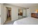 Cozy bedroom featuring carpeted floors, mirrored closet, and en suite bathroom at 964 Leisure World --, Mesa, AZ 85206