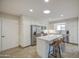 Bright kitchen featuring stainless appliances, white cabinets, and eat-in island with skylight at 964 Leisure World --, Mesa, AZ 85206