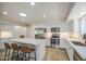 Spacious kitchen features stainless appliances, white cabinets, eat-in island, and subway tile at 964 Leisure World --, Mesa, AZ 85206