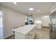 Bright kitchen with white island, quartz countertops, stainless appliances, and tile flooring at 964 Leisure World --, Mesa, AZ 85206