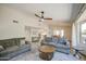 Bright living room features neutral walls, plush sofas, a ceiling fan and an open view to the kitchen and dining area at 964 Leisure World --, Mesa, AZ 85206