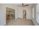 Bright living room with tile floors, view to kitchen, and contemporary ceiling fan at 964 Leisure World --, Mesa, AZ 85206