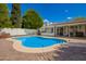 Aerial view of a backyard with pool, covered patio, and lush landscaping at 1002 E Topeka Dr, Phoenix, AZ 85024