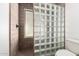Bathroom featuring glass block shower with neutral tile and contemporary fixtures at 1002 E Topeka Dr, Phoenix, AZ 85024