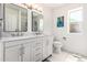 This modern bathroom features a dual sink vanity, toilet, and a window at 1002 E Topeka Dr, Phoenix, AZ 85024