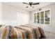 A bedroom showcases a window with shutter blinds, white walls, and a closet at 1002 E Topeka Dr, Phoenix, AZ 85024