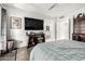 Main bedroom featuring neutral walls, hardwood floors, ceiling fan, and a television at 1002 E Topeka Dr, Phoenix, AZ 85024