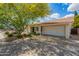Well-maintained single-story home featuring an attached two-car garage and desert landscaping at 1002 E Topeka Dr, Phoenix, AZ 85024