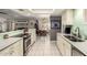 Modern kitchen with white cabinetry overlooking dining area and living spaces at 1002 E Topeka Dr, Phoenix, AZ 85024