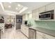 Bright kitchen with white cabinets, stainless steel appliances, and tiled backsplash at 1002 E Topeka Dr, Phoenix, AZ 85024