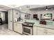 Well-lit kitchen showcasing modern stainless steel appliances, tile floor, and ample countertop space at 1002 E Topeka Dr, Phoenix, AZ 85024