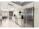 Bright kitchen featuring stainless steel appliances, light cabinetry, tile floor, and eat-in dining area at 1002 E Topeka Dr, Phoenix, AZ 85024