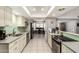 Bright kitchen featuring tile floors, light cabinetry, stainless appliances and a stylish tile backsplash at 1002 E Topeka Dr, Phoenix, AZ 85024