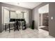 Office space featuring tile floors, neutral gray walls, and a large bay window with shutter shades at 1002 E Topeka Dr, Phoenix, AZ 85024