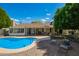 Bright backyard featuring a refreshing pool, covered patio, and charming outdoor seating with a fire pit at 1002 E Topeka Dr, Phoenix, AZ 85024