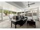 Enclosed sunroom with a ceiling fan, a seating area, and plenty of sunlight at 1002 E Topeka Dr, Phoenix, AZ 85024