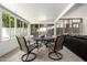 A sunroom offers seating for four at a round table for relaxation and enjoyment at 1002 E Topeka Dr, Phoenix, AZ 85024