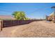Fenced backyard with desert landscaping, providing privacy and a serene outdoor space at 10177 E La Palma Ave, Gold Canyon, AZ 85118