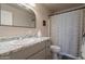 Clean bathroom featuring a granite countertop vanity and shower with a striped curtain at 10177 E La Palma Ave, Gold Canyon, AZ 85118
