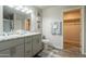 Bathroom featuring a dual sink vanity, toilet, and shower, with a closet for storage at 10177 E La Palma Ave, Gold Canyon, AZ 85118