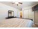 Bright bedroom featuring a ceiling fan, dresser with mirror, and closet for ample storage at 10177 E La Palma Ave, Gold Canyon, AZ 85118