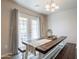 Dining area featuring a long wooden table with bench seating and sliding glass doors at 10177 E La Palma Ave, Gold Canyon, AZ 85118