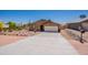 Single story home with desert landscaping, concrete driveway, and direct access to a two-car garage at 10177 E La Palma Ave, Gold Canyon, AZ 85118