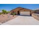Charming single story home with an attached two car garage, desert landscaping, and tiled roof at 10177 E La Palma Ave, Gold Canyon, AZ 85118