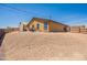 Exterior shot of the home showcasing the backyard, desert landscaping, and overall curb appeal at 10177 E La Palma Ave, Gold Canyon, AZ 85118