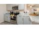Modern kitchen boasts stainless steel appliances, gray cabinetry, and granite countertops at 10177 E La Palma Ave, Gold Canyon, AZ 85118