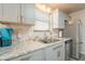 Updated kitchen features grey cabinets, modern appliances, and granite countertops at 10177 E La Palma Ave, Gold Canyon, AZ 85118