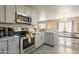 Modern kitchen features stainless steel appliances, gray cabinets, and granite countertops at 10177 E La Palma Ave, Gold Canyon, AZ 85118