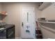 The laundry area includes a gray washer and dryer plus storage space at 10177 E La Palma Ave, Gold Canyon, AZ 85118
