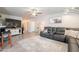 Comfortable living room featuring a modern entertainment center and a large sectional sofa at 10177 E La Palma Ave, Gold Canyon, AZ 85118