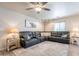 Relaxing living room with a large leather sectional, modern ceiling fan, and lots of natural light at 10177 E La Palma Ave, Gold Canyon, AZ 85118