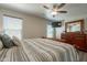 Main bedroom boasts a ceiling fan and dresser with a mirror at 10177 E La Palma Ave, Gold Canyon, AZ 85118