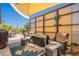 Relaxing covered patio with wicker furniture, decorative rug, and charming desert accents for outdoor living at 10177 E La Palma Ave, Gold Canyon, AZ 85118
